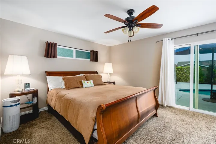 Spacious Primary Bedroom with sliding glass door leading to backyard