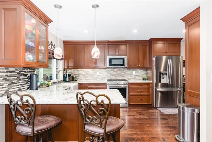 Gorgeous remodeled kitchen with custom birch cabinets, granite countertops and stainless steel appliances