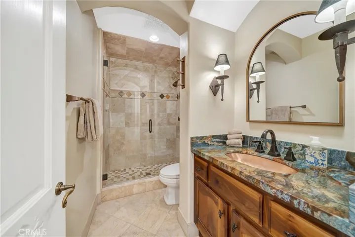 Glass shower with stone counter tops.