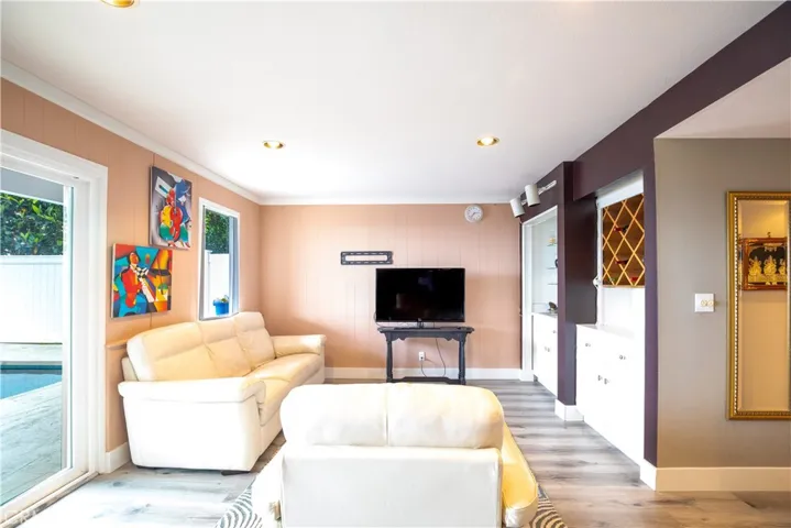 Downstiars family room with wet bar and doors to pool area