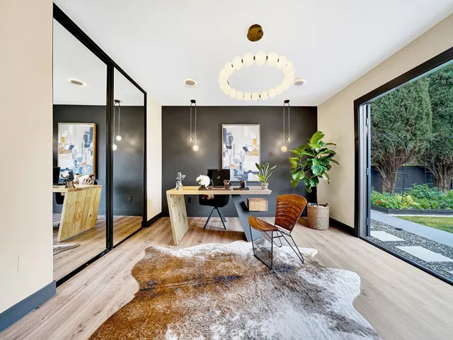 One of the primary suites, has full bathroom, opens to the backyard directly to the lush vegetable garden .
