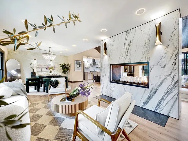 It boasts a dramatic 15-ft dual-sided fireplace that divides the living , kitchen and family room areas