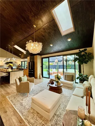 The lovely family room has a stunning Visual Comfort bubble chandelier…… and it opens to the large backyard