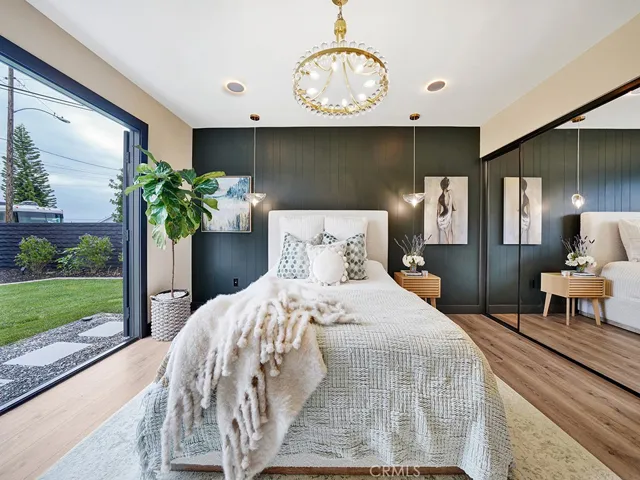 Master suite opens to the backyard….highlighted with stylish chandelier and accent wall