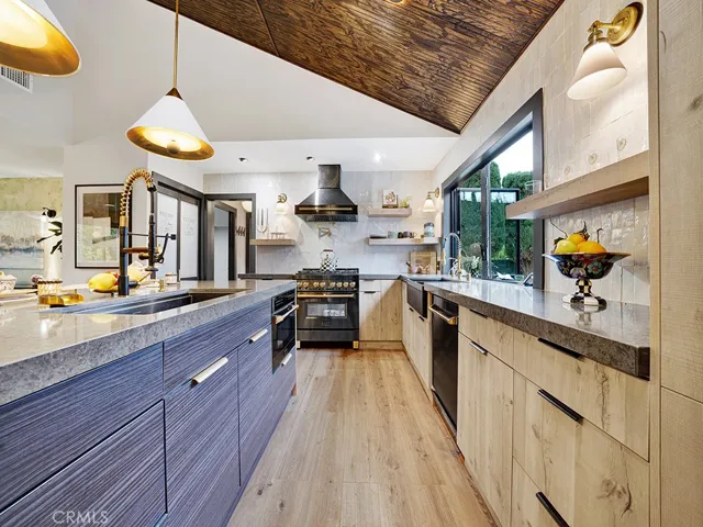 Highly upgraded kitchen features custom two tone soft closing cabinets, two sinks, built in custom shelves and Moroccan Zellige handmade tile backsplash