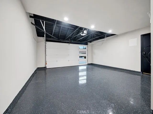 Nothing was spared, garage is immaculately re-finished with epoxy coated flooring, overhead storage space and brand new modern garage door.