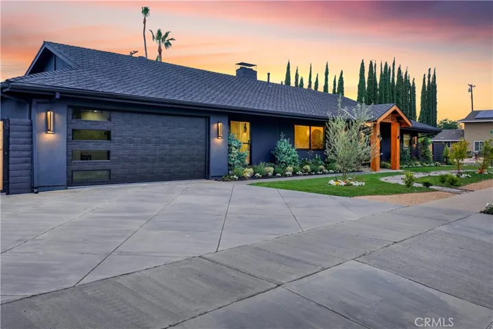 Dramatic exterior lighting and modern garage door