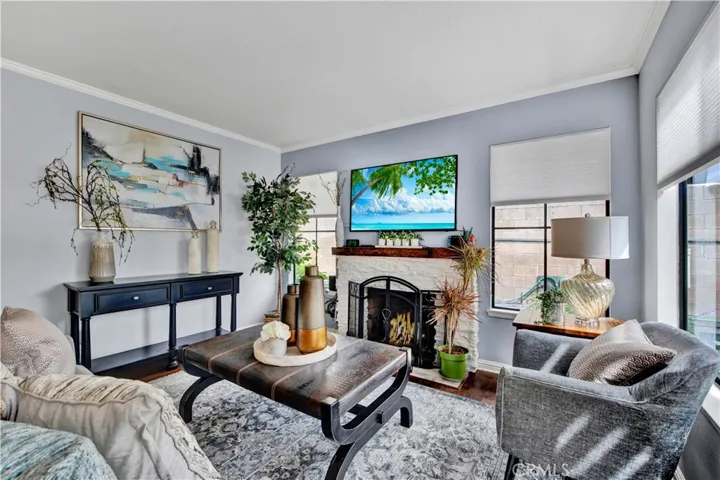 Family Room with Stacked White Stone Fireplace and is Open to the Kitchen