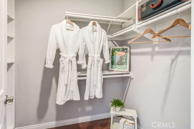 Primary walk-in closet with shelves and drawers
