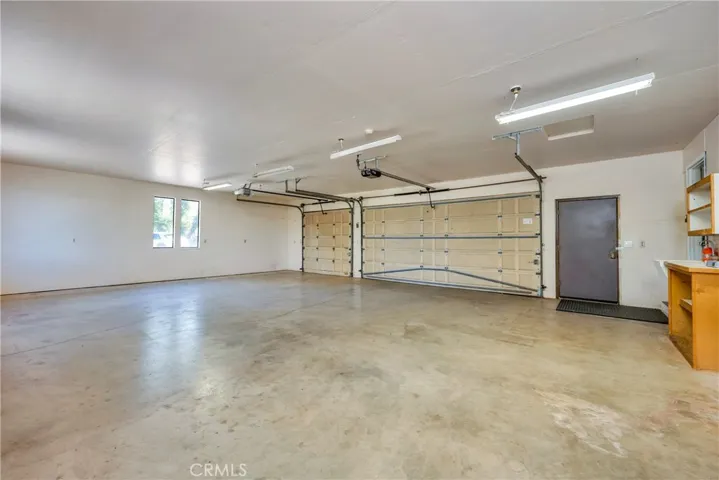 Oversized 3 car garage with utility sink & workshop area