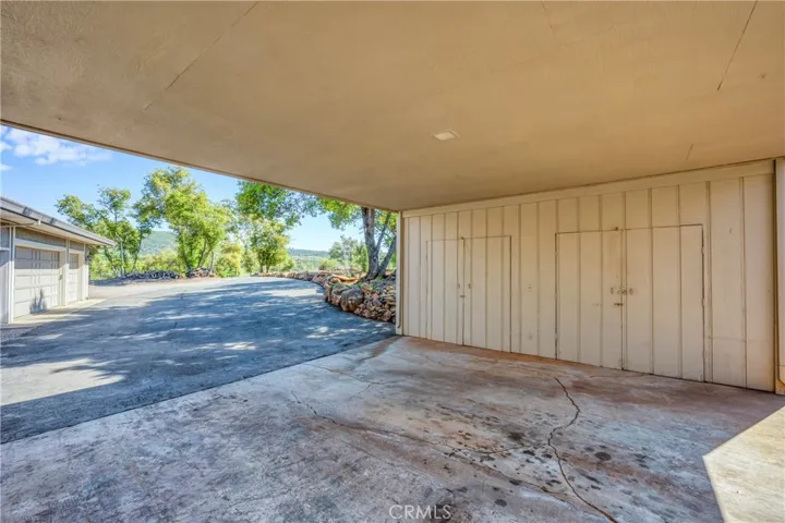 Carport with storage rooms for wood storage