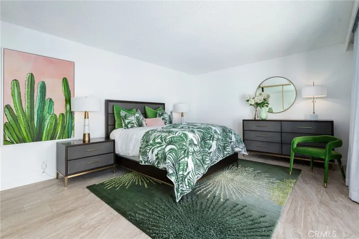 Primary bedroom has a sliding glass door that opens to the front private patio.