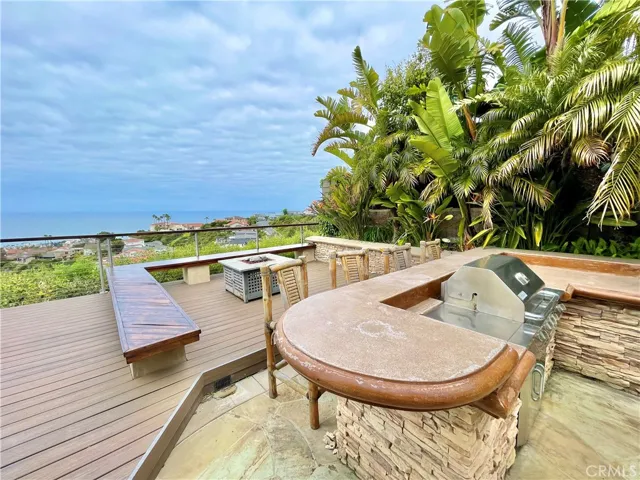 Backyard has Built-on BBQ with seating, a firepit - and incredible views