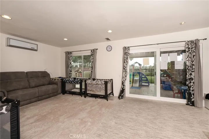 Recreation Room with door to fenced patio play yard.