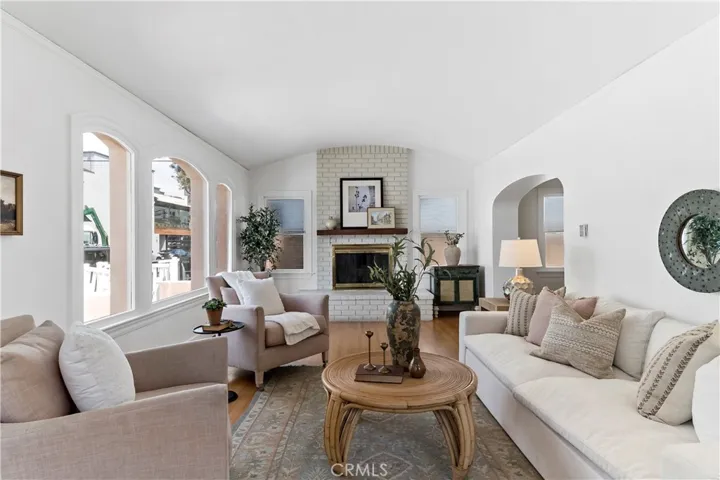 Living room with barrel ceiling and large front windows.