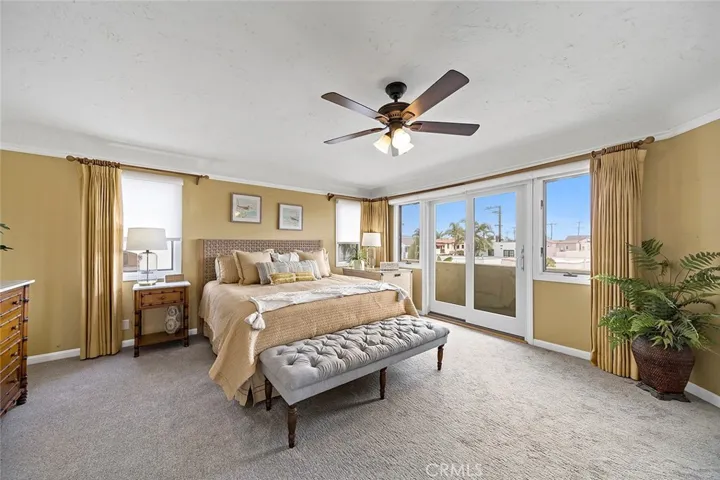 Luxurious primary suite with its Juliet balcony to let the ocean breezes in