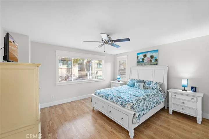 The ample primary bedroom has lots of natural light and a ceiling fan.  Notice the upgraded baseboards (throughout the home) and the craftsman-like encased windows (again, throughout the home).