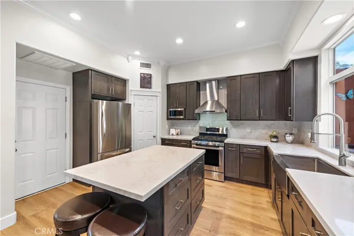 Now this is a KITCHEN!  Recently remodeled with today's designer trends, it offers quartz counters, soft close cabinets and drawers, stainless appliances and stainless farm-style sink and a stainless hood.
