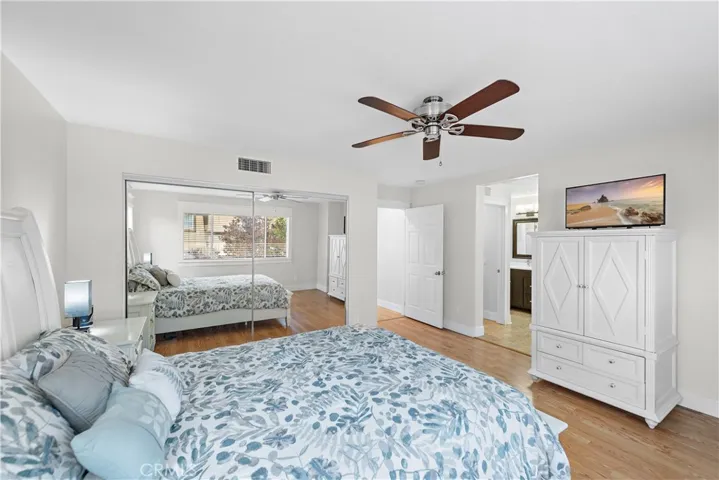 The mirrored wardrobe is one of two closets in the primary bedroom.