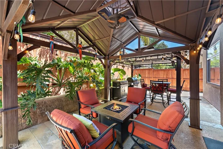 Welcome to your backyard tropical paradise boasting two quality gazebos (each with added lighting and a fan for air circulation).  The two outdoor cooking appliances remain with the home too!