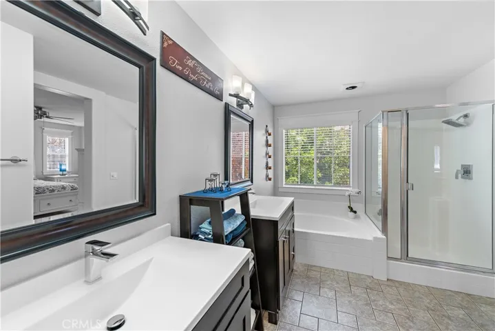 The primary bathroom has a separate tub and shower and dual vanities.