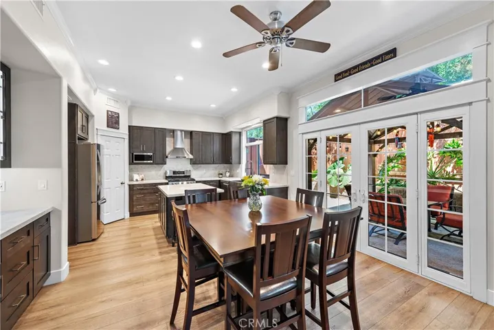 The dining area flows seamlessly between the kitchen and the family room.  Check out the built-in cabinets and buffet to the left and french doors leading to your outdoor living space.
