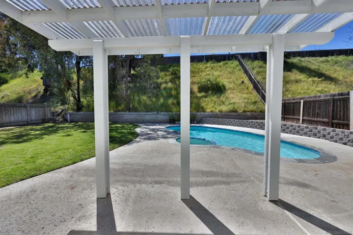 Partially covered patio for al fresco dining pool-side