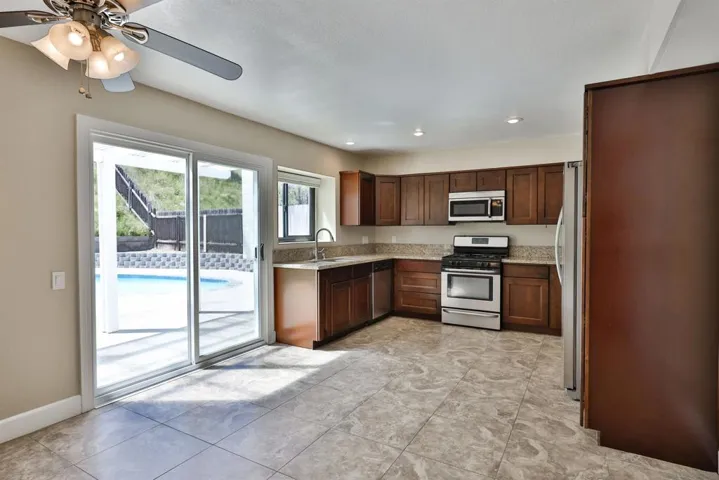 Kitchen with sliding glass door out to backyard/pool area