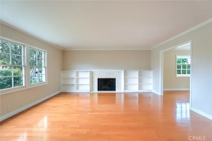 Living room connects to the formal dining room with hardwood floors.