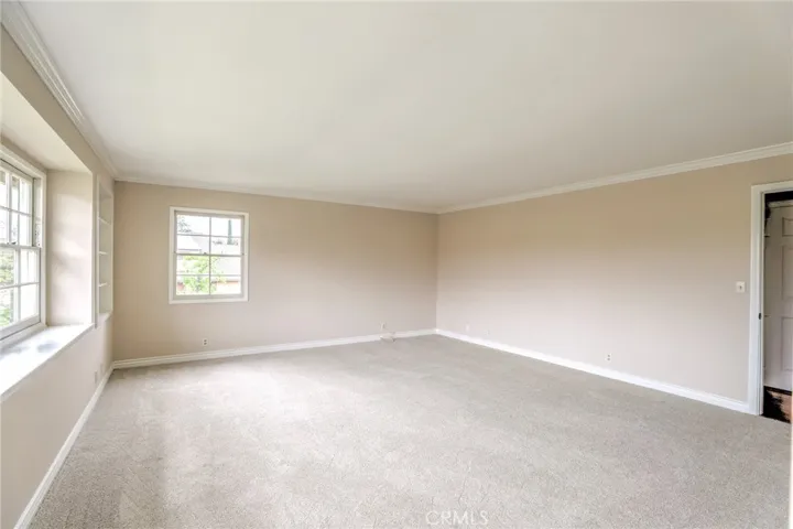 Large primary suite with large windows, crown molding, brand new carpet and lots of natural light!