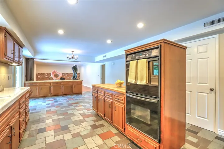 The large kitchen with butcher block center island and double oven