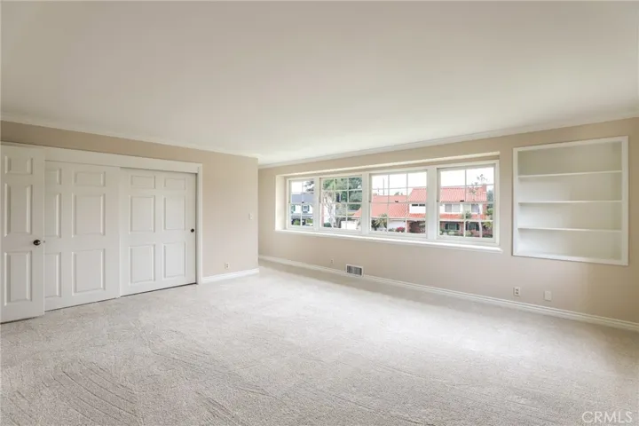 Large primary suit with large closet and built in bookcase.