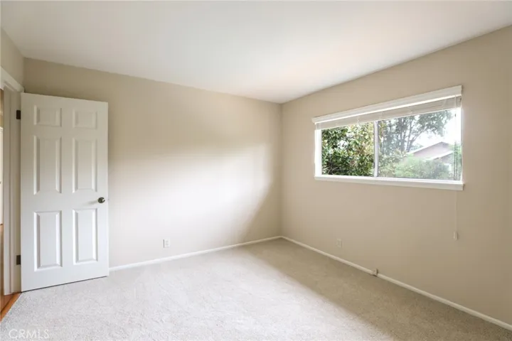 Bedroom #4 with large window and brand new carpet.