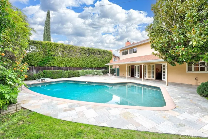 The private sparkling pool with fabulous stone decking and lush landscaping!