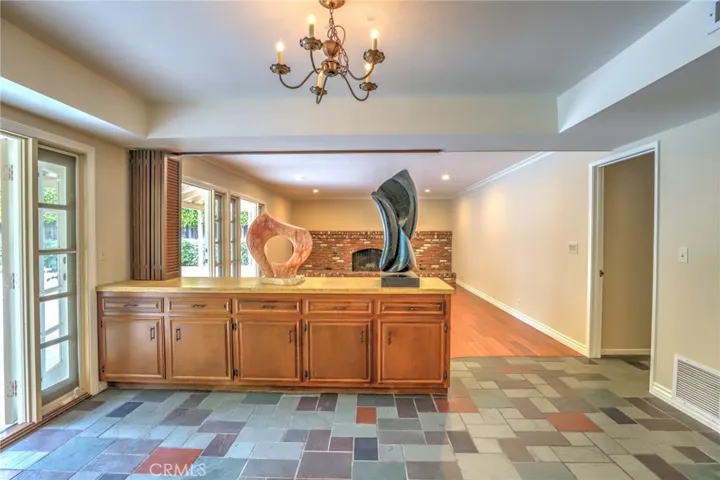 The kitchen looking towards the family room with hardwood floors and a magnificent brick fireplace!