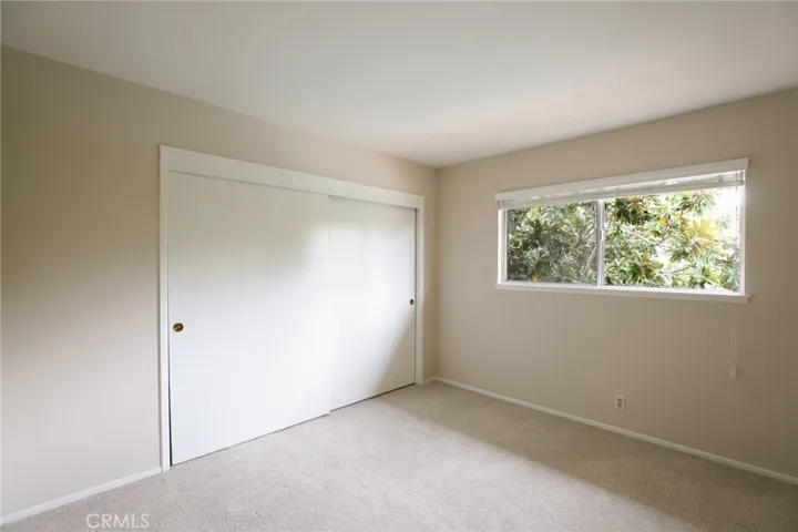 Bedroom #3 with large window and brand new carpet.