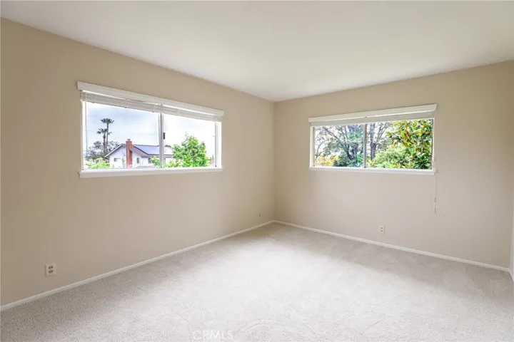 Bedroom #2 with large windows and brand new carpet.