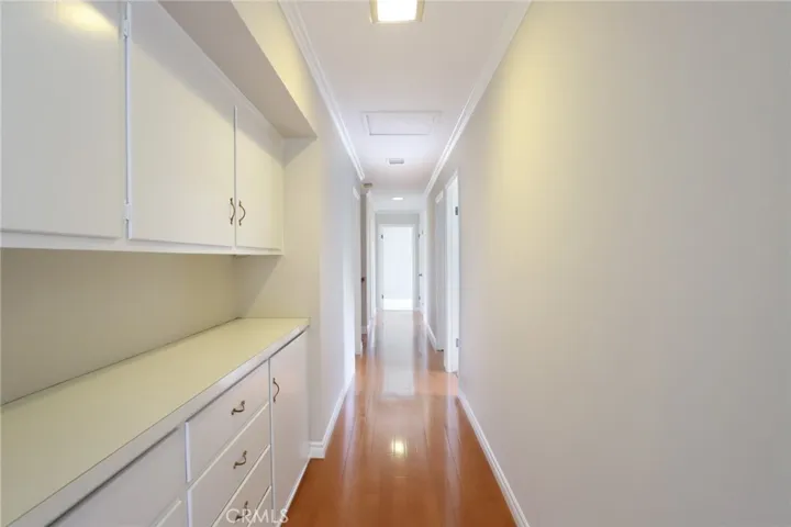 Upstairs hallway with hardwood floors and large built-in storage cabinet!