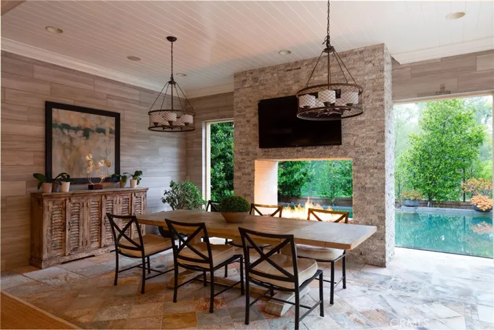 Cozy fireplace nestled in the California room for year-round entertaining.