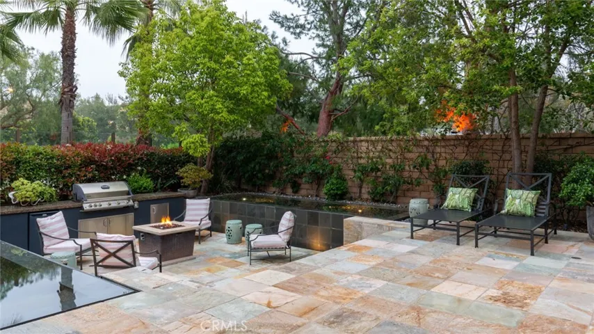 Manicured lawn and landscaped backyard.