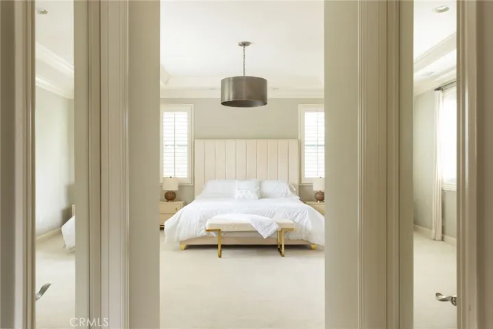 Spacious primary bedroom with his and her walk-in closets.