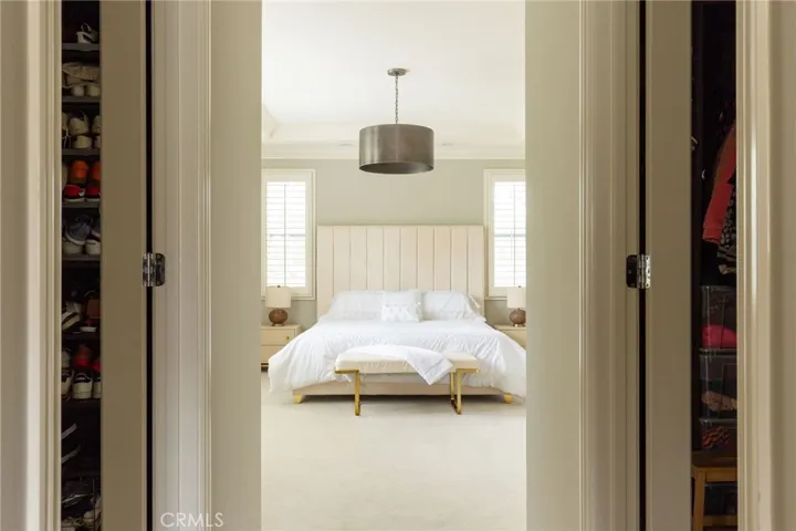 Elegant master suite with his and her walk-in closets.