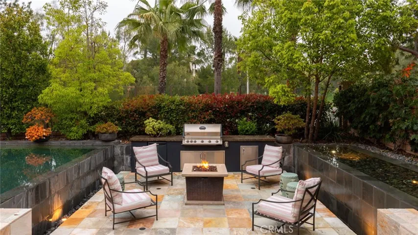 Inviting backyard oasis with infinity pool and water features.