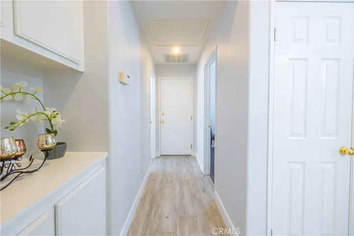 Hallway to 2 other Bedrooms and garage entry door