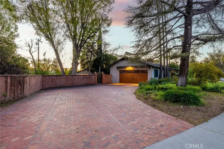 Beautifully crafted brick driveway with a sweeping turn to the attached two car garage.