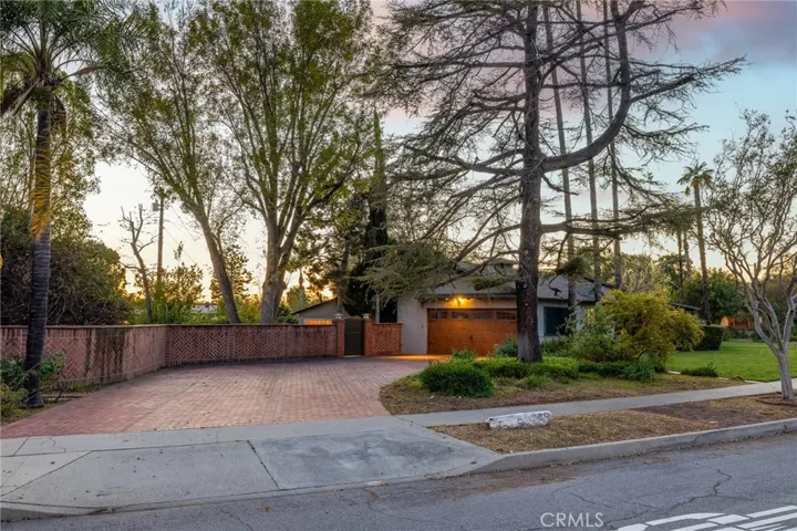 Brick driveway and garage entry.