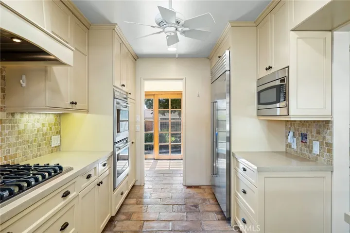 Kitchen towards the back breakfast nook with a sliding door to the backyard.