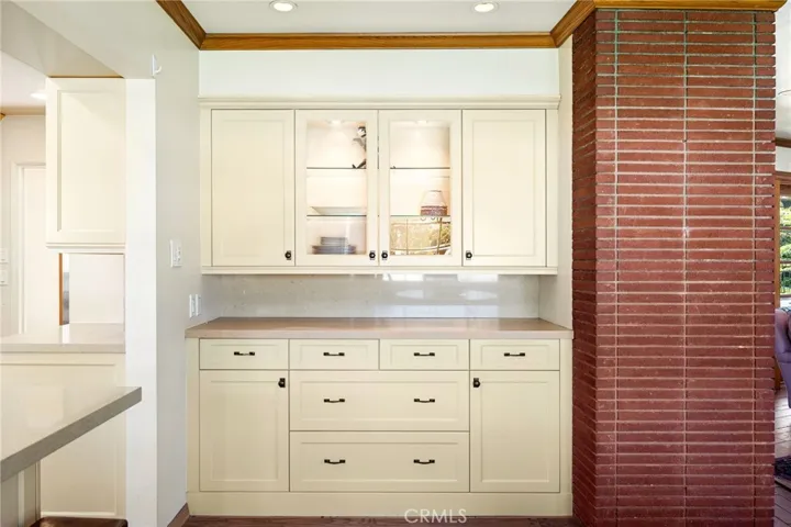 Custom built-in buffet with brick accent wall.