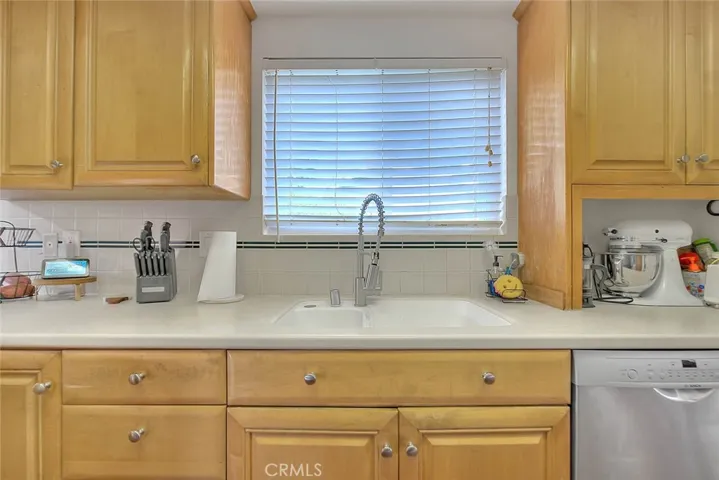 Kitchen w/Maple Cabinetry and Corian Countertops.