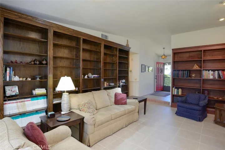 Family room features an abundance of built in custom bookcases